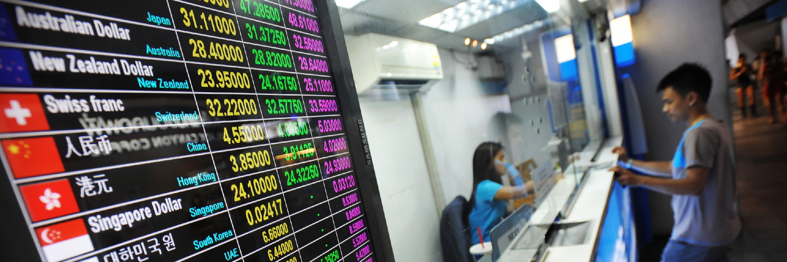 Tourist exchange rates at a streetside booth as the Thai Baht falls for the 7th week on June 9, 2013 in Bangkok, Thailand